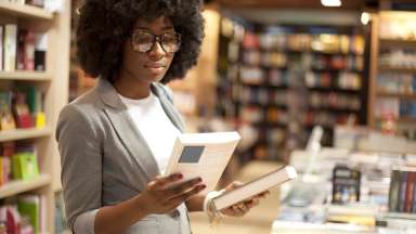 a girl reading a book in a store