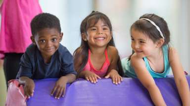 young children playing on tumble toy