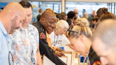 Raleigh Police Chief Boyce fills boxes with food along with other volunteers