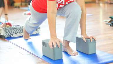 people doing yoga with blocks