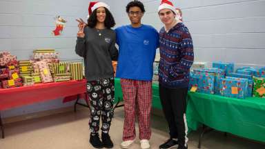 teens helping giving out toys