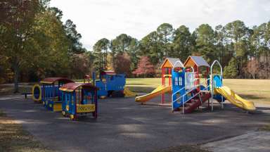 A large playground for kids with a rubber surface
