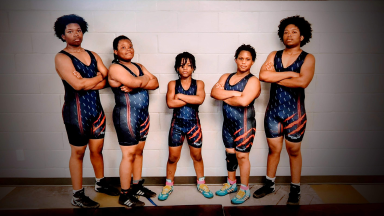 young wrestlers in uniform posing
