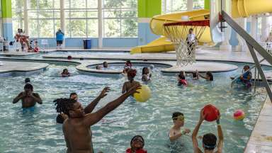 patrons playing in the pool