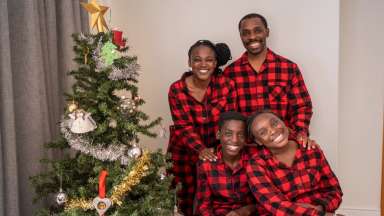 a family in their holiday pajamas near the christmas tree