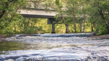 a bridge on the Neuse River and water flowing