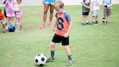 a kid playing with a soccer ball