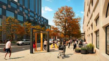 Streetscape showing an artistic metal wayfinding sign.