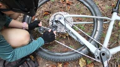 a guy doing maintenance on his bike