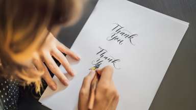 a person writing in calligraphy