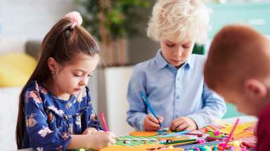 a group of focused children during an art program