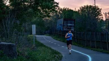 a runner on a paved trail