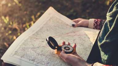 a person holding a map and compass