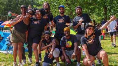 a group of people smiling at an outdoor event
