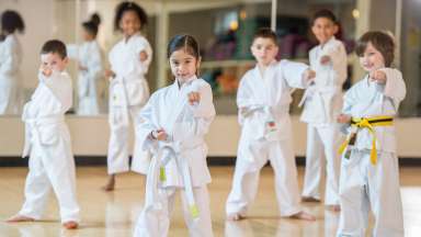 children in a class learning self-defense