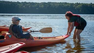 kayaking at a lake with while going in the water