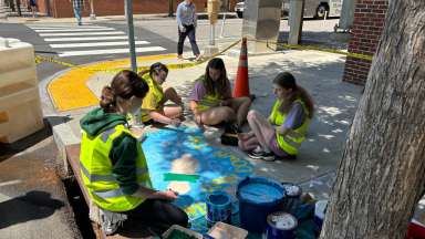 Artists completing street art