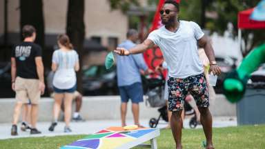 man playing cornhole