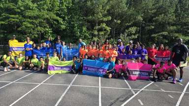 a group of children with their track coaches