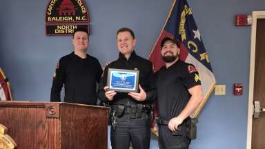 Raleigh police officer receives award at podium