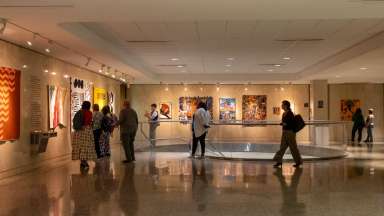 Gallery space with people enjoying an art opening