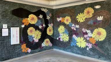 Corner chalk wall with colorful mural with flowers and a snake