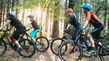 people on a trail mountain biking