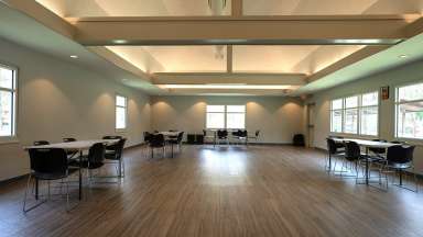 A large, open meeting room with tables and chairs 