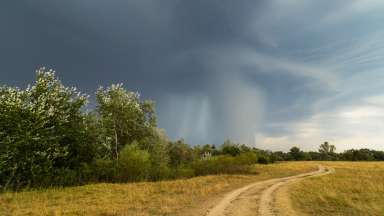 Tornado clouds over dirt road