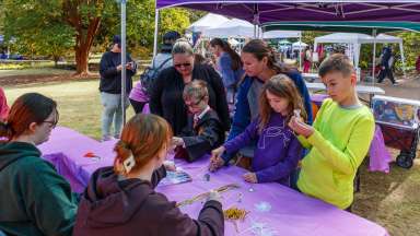 a group of volunteers of all ages meeting a table