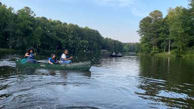 NEC students on canoes and spraying water