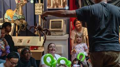 children at the city of Raleigh museum watching a puppeteer