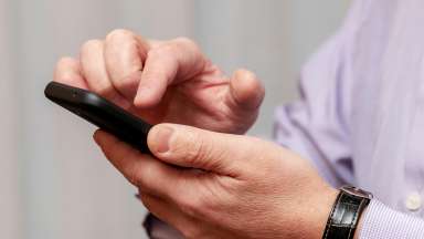 a close up of an adult using an iphone