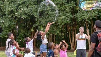 children playing with bubbles in a field