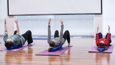 people using a soft foam roller to do an exercise