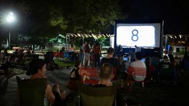 a crowd watching an outdoor movie