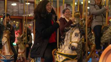 a person riding a horse on a carousel