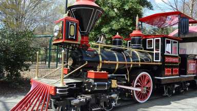 a black and red amusement train at Pullen park