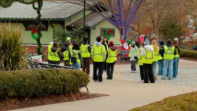 a group of volunteers at Pullen park wearing safety vests