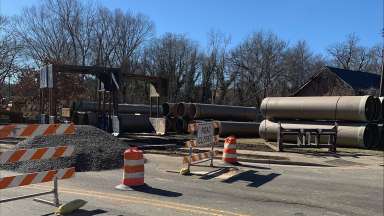 Metal pipes on asphalt road