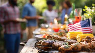 People standing behind grill for celebration