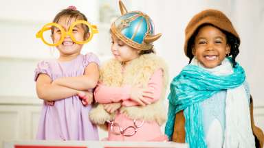 three children playing dress up