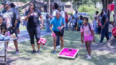 a family playing cornhole and enjoying the outdoors