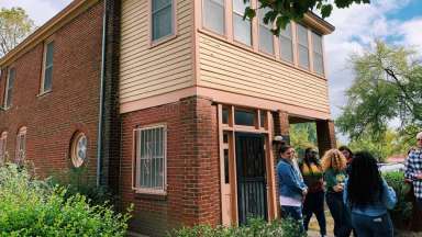The outside of the Pope House Museum with a group of people standing outside