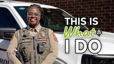 Animal control officer standing in front of white truck