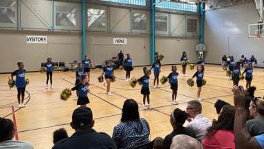 a cheer squad on a basketball court