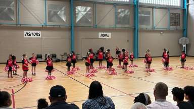 a cheer squad on a basketball court
