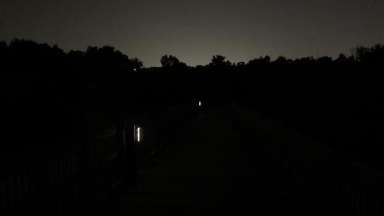 a greenway trail bridge at night with solar lights at 20% luminosity