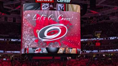 Lenovo Center scoreboard with Carolina Hurricanes symbol and "let's go Canes"