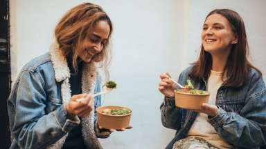 Two people eating food.